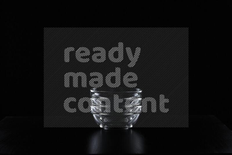 Glassware with rim light against black background