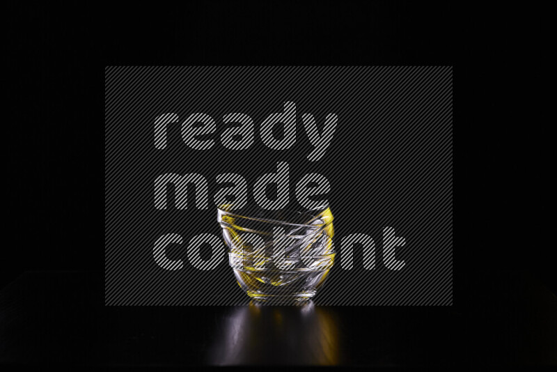 Glassware with rim light in yellow and white against black background