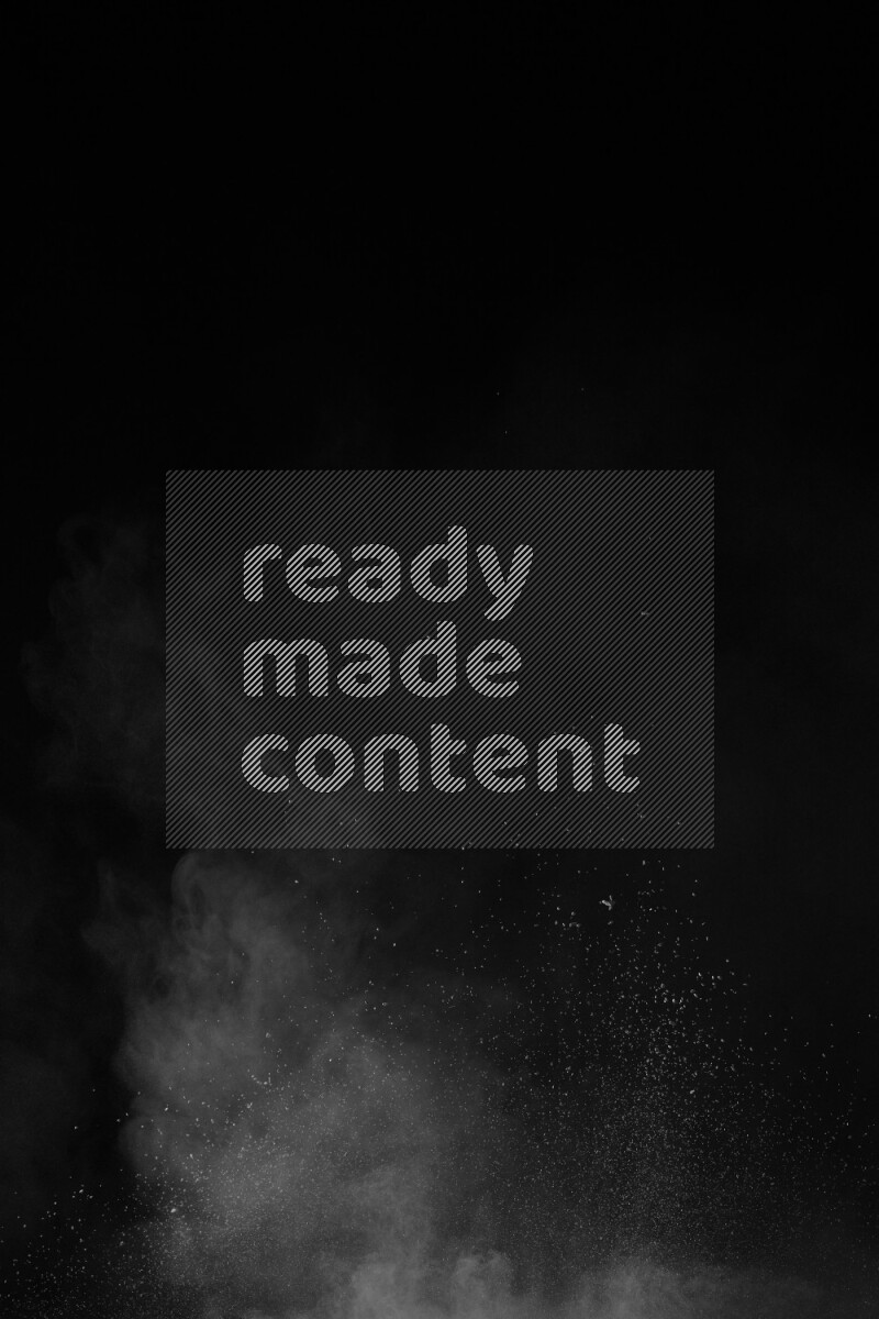 A side view of white powder explosion on black background