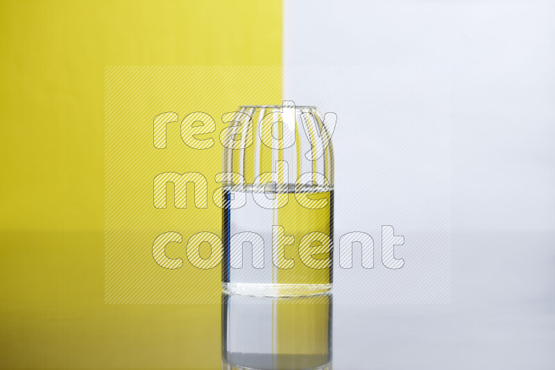 The image features a clear glassware filled with water, set against white and yellow background