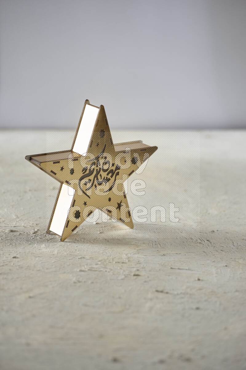 A lantern placed on a textured white background