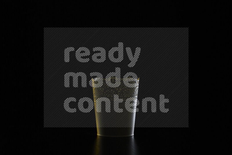 A plant pot with colored rim light against black background