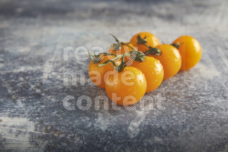 yellow cherry tomato vein on a textured rusty blue background 45 degree