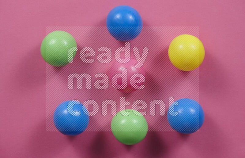 Multicolored plastic balls on different colored backgrounds (kids toys)