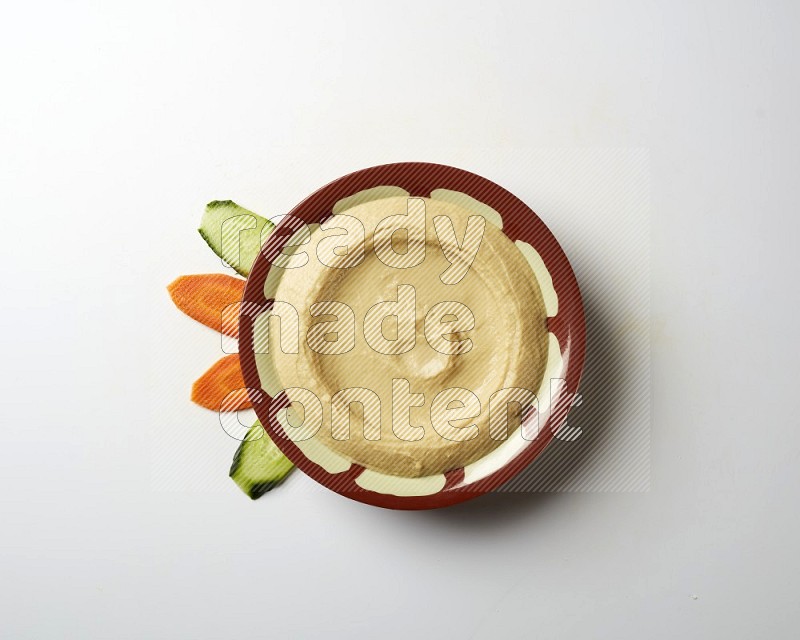 Plain hummus in a traditional plate on a white background