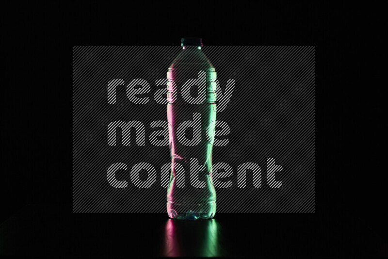 Water bottle with colored rim light against black background