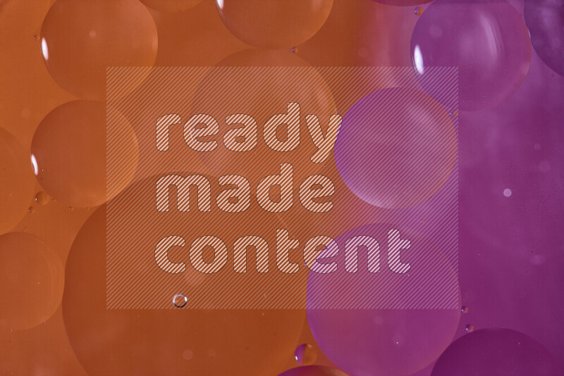 Close-ups of abstract oil bubbles on water surface in shades of orange and pink