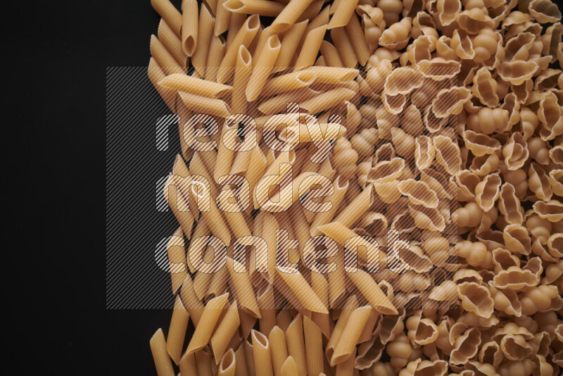 Different pasta types on black background