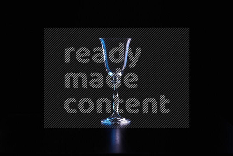 Glassware with rim light in blue and white against black background