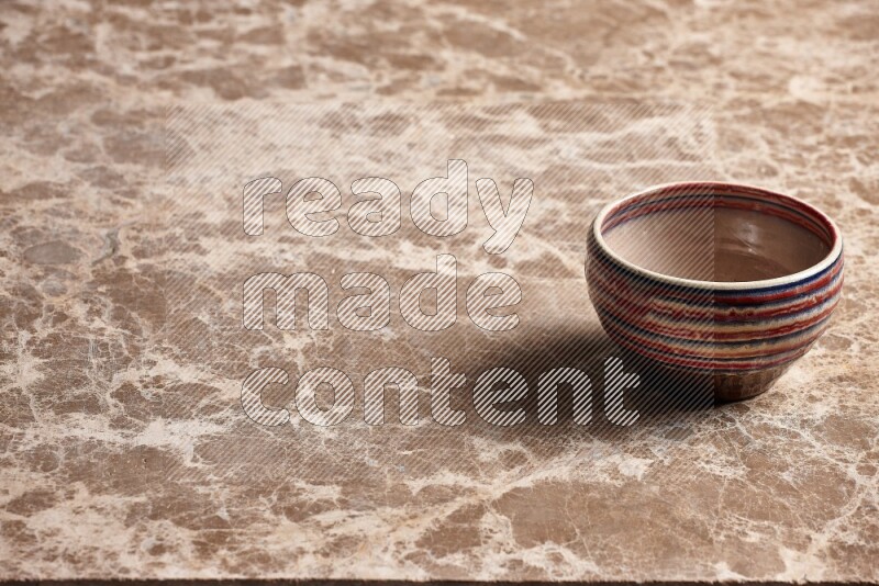 Multicolored Pottery Bowl on Beige Marble Flooring