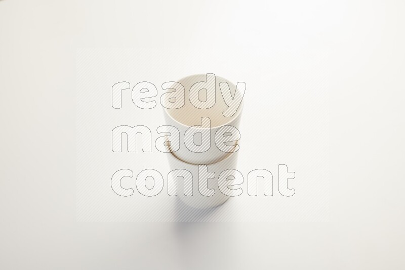 white ceramic cup on white countertop
