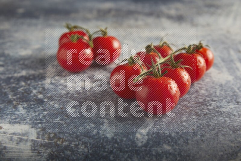 Red cherry tomato vein on a textured rusty blue background 45 degree