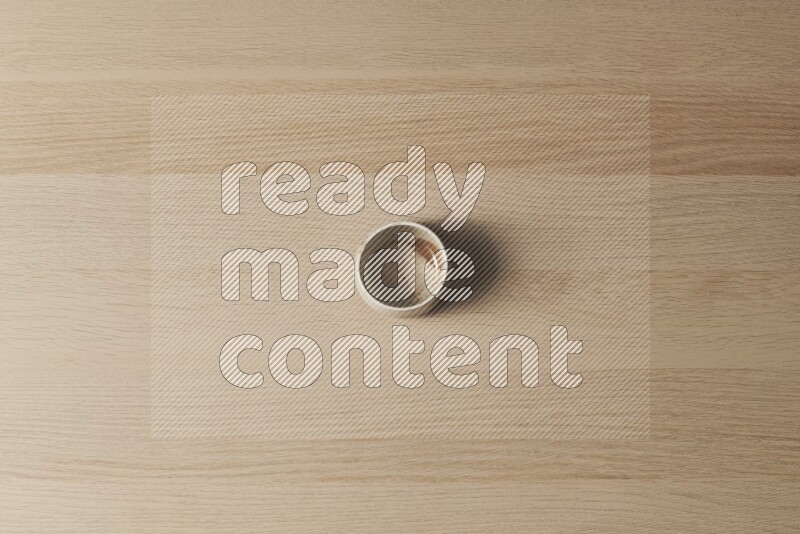 كأس فخاري على خلفية خشبية فاتحة