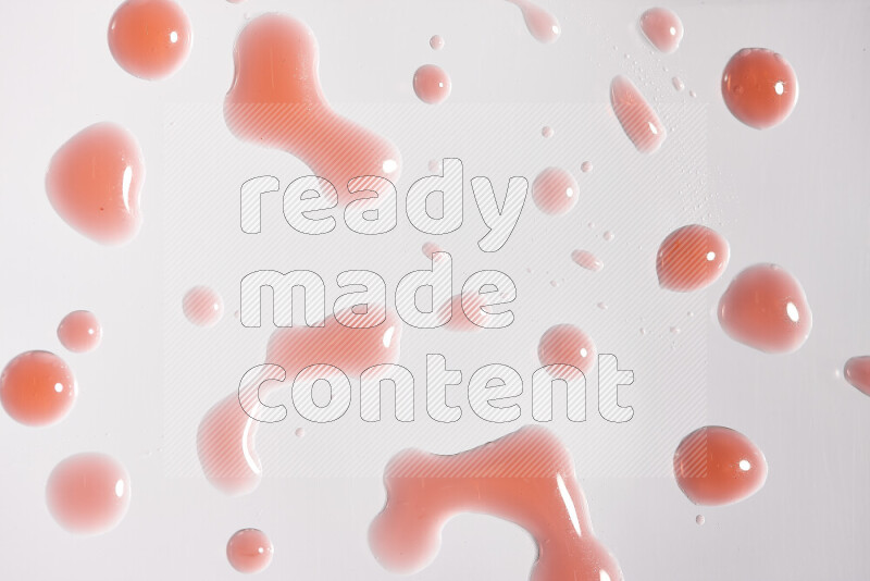 لقطات مقربة لقطرات من اللون الأحمر على خلفية بيضاء