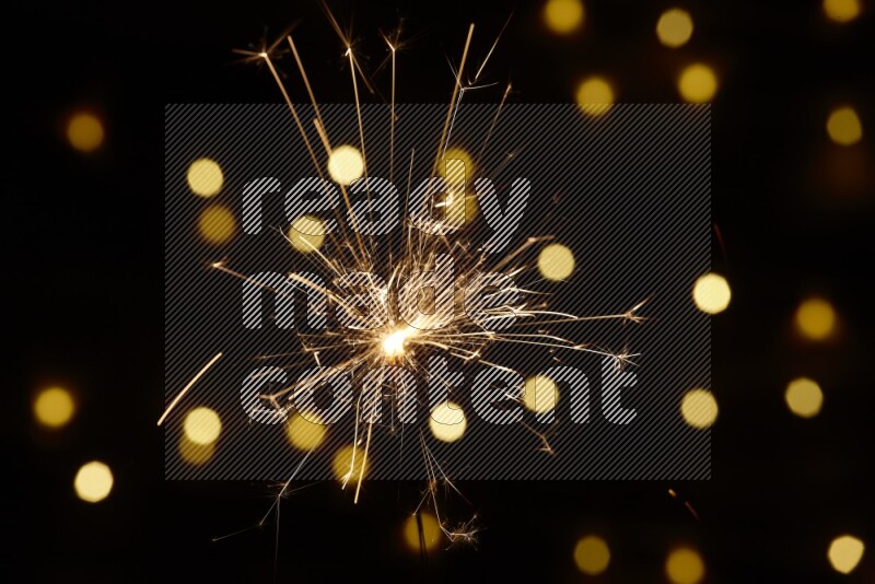 Sparkler candle with yellow light bokeh background