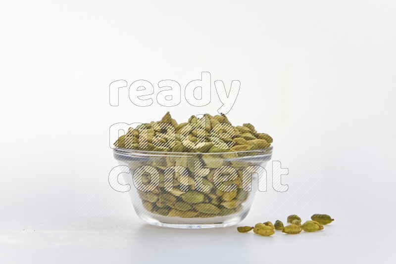 Cardamon in a container on white background