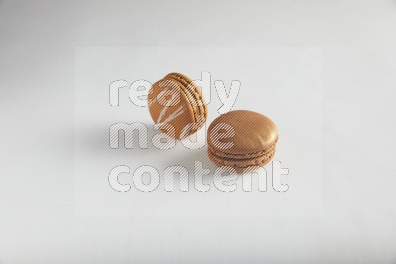 45º Shot of of two assorted Brown Irish Cream, and Brown Coffee macarons  on white background