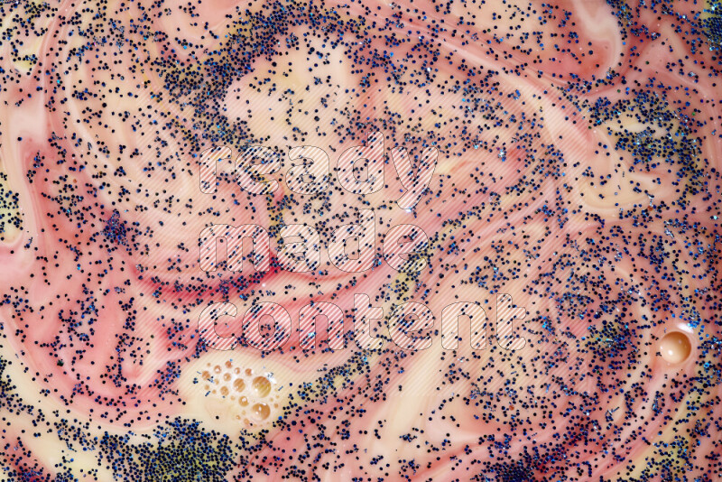 لقطة مقربة لبريق أزرق متلألئ منتشر على خلفية من اللون الأصفر والأحمر في حركات دائرية