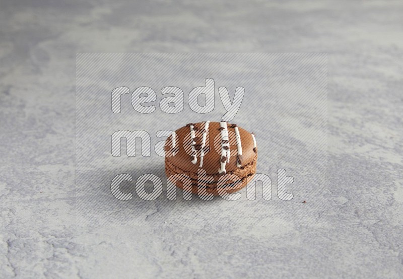45º Shot of Brown white Chocolate Caramel macaron on white  marble background