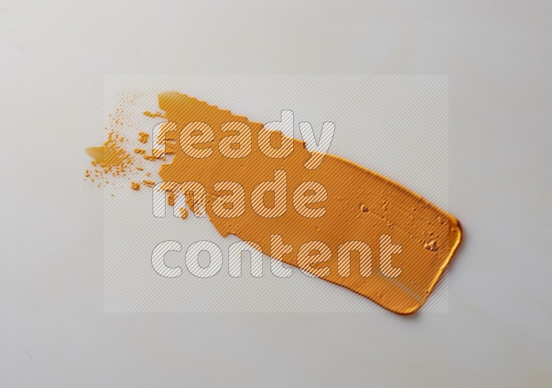 An orange straight painting knife stroke on white background