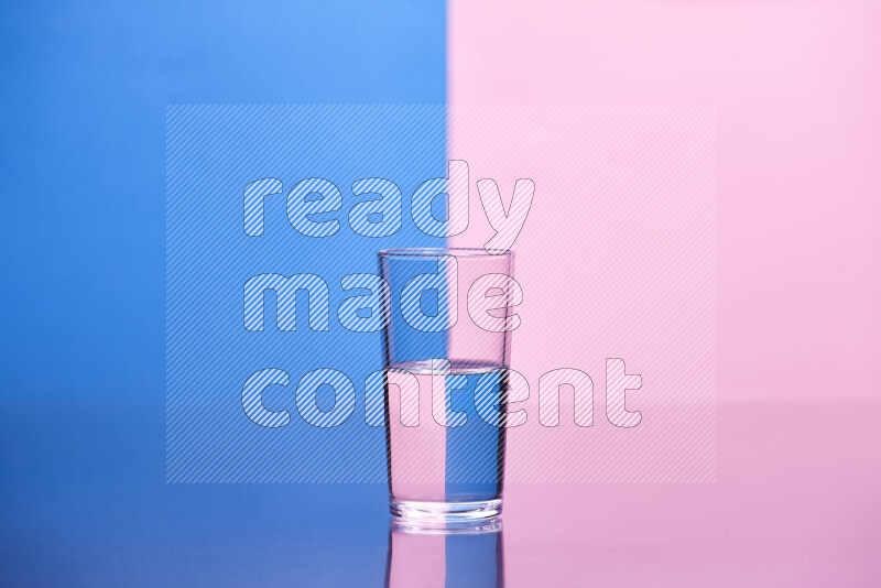 The image features a clear glassware filled with water, set against blue and rose background