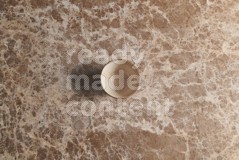 A white pottery bowl on beige marble background