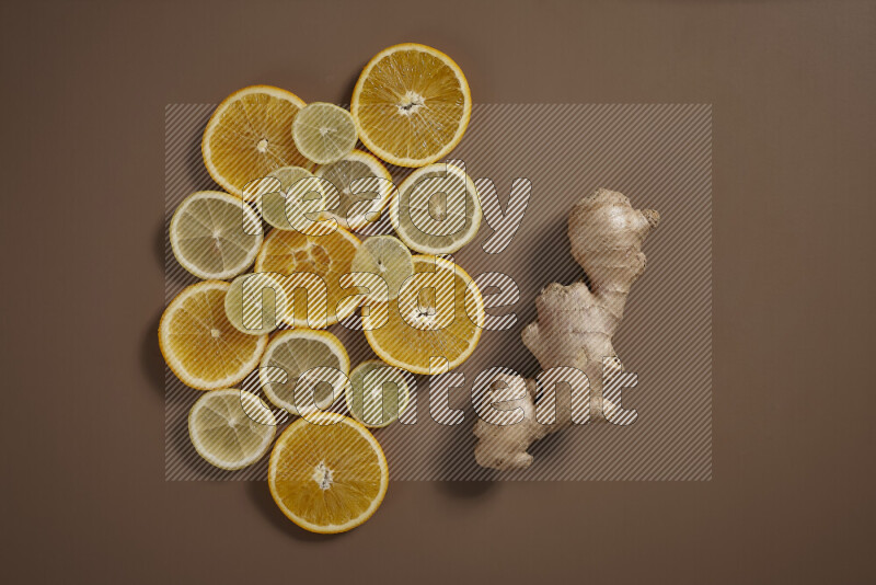 Fresh ginger root with different ingredients such as lemon, orange, honey, ground ginger on beige baackground