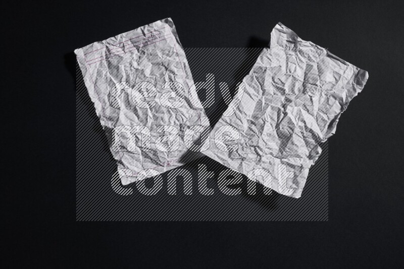 Crumpled notebook sheet on black background
