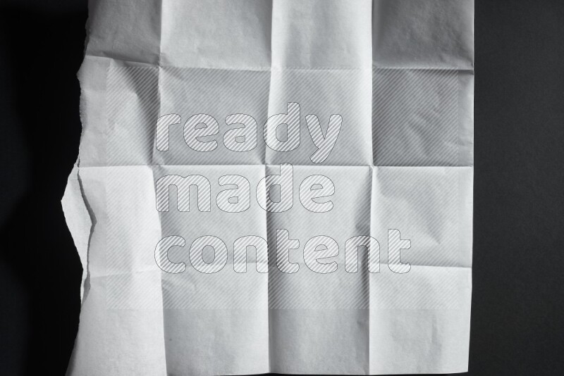 White paper sheet on black background