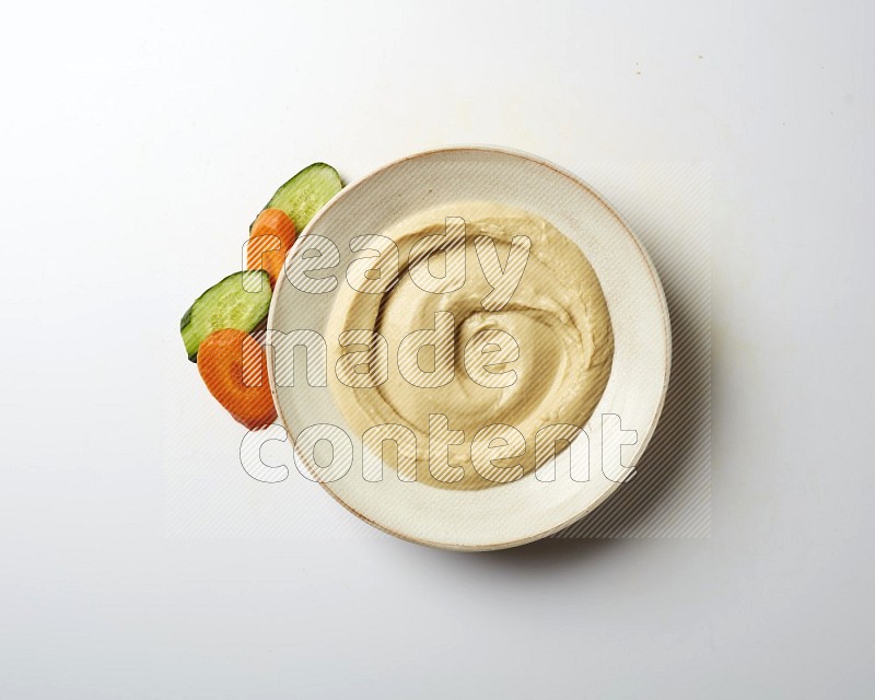 plain Hummus in a pottry plate  on a white background