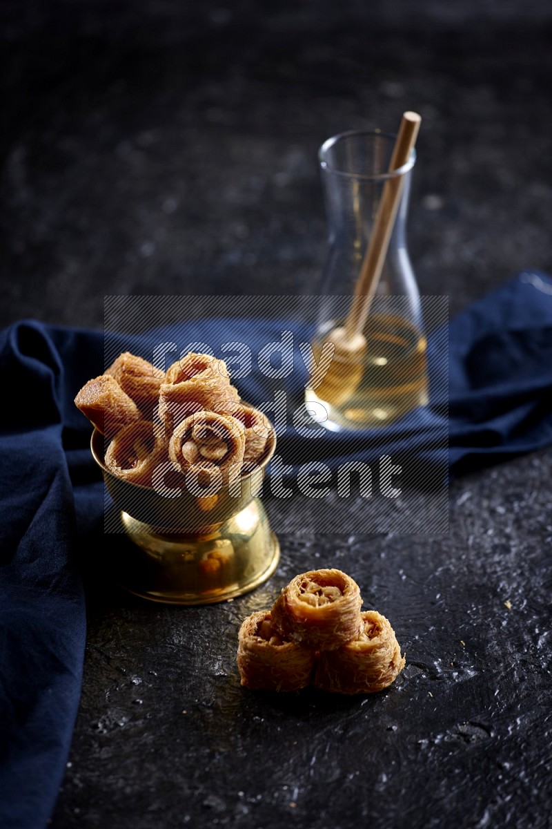 konafa in a metal bowl in a dark setup