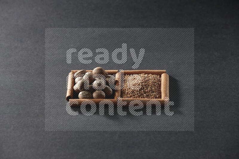 2 squares of cinnamon sticks full of mustard seeds and nutmeg on black flooring