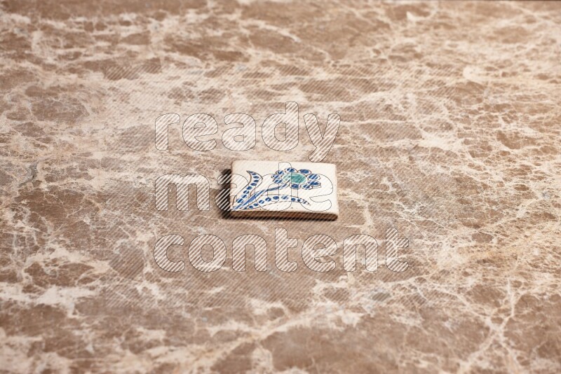 A decorative coaster on beige marble background