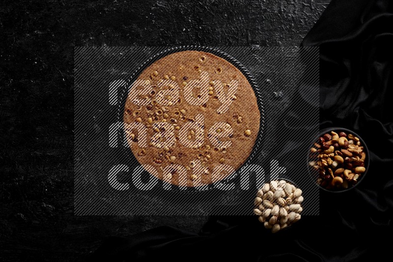 Basbousa with nuts and honey in a dark setup