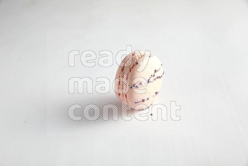 45º Shot of pink orange blossom macaron on white background