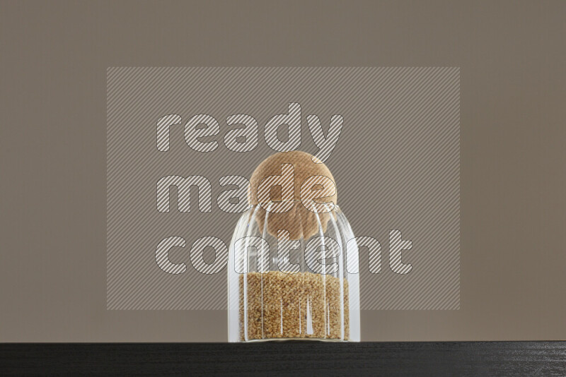 Sesame in a glass jar on black background