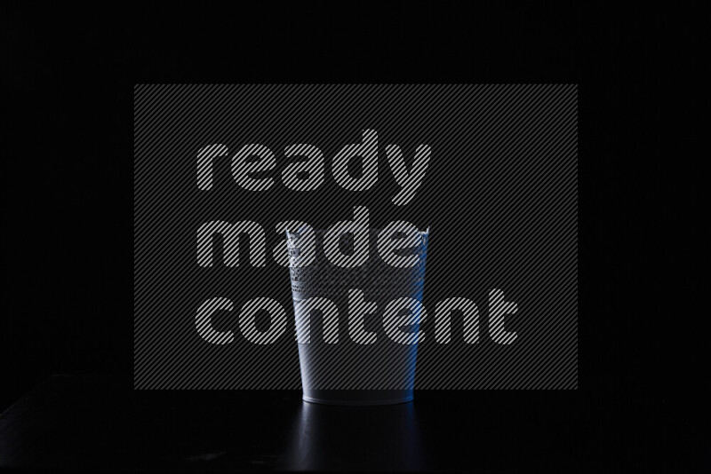 A plant pot with colored rim light against black background