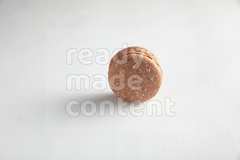 45º Shot of Brown Hazelnuts macaron on white background