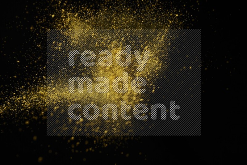 Yellow powder explosion on black background