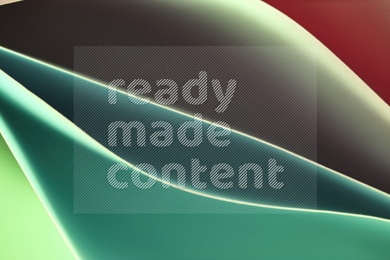 This image showcases an abstract paper art composition with paper curves in green and red gradients created by colored light