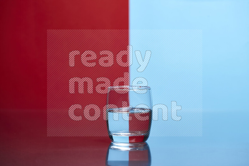 The image features a clear glassware filled with water, set against red and light blue background