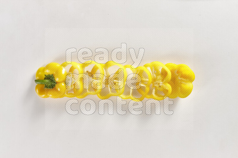 Yellow bell pepper slices on white background