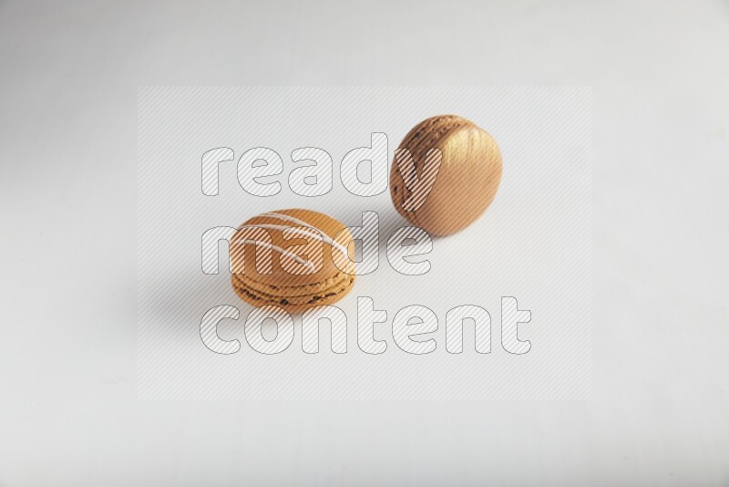 45º Shot of of two assorted Brown Irish Cream, and Brown Coffee macarons  on white background