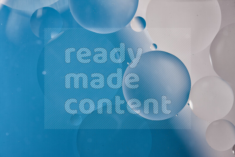 Close-ups of abstract oil bubbles on water surface in shades of white and blue