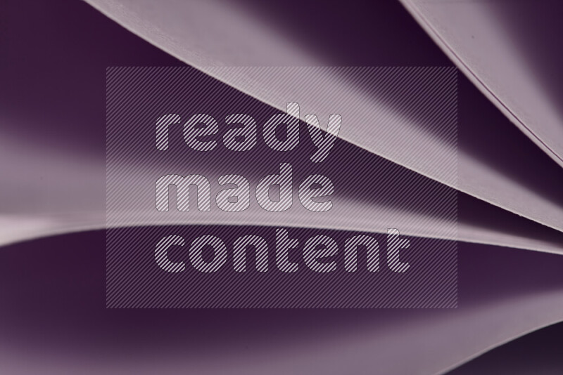 An abstract art showing purple paper sheets arranged in an overlapping curves
