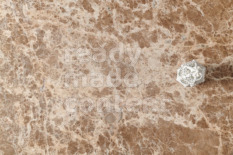 Top View Shot Of Candle Lantern On beige Marble Flooring