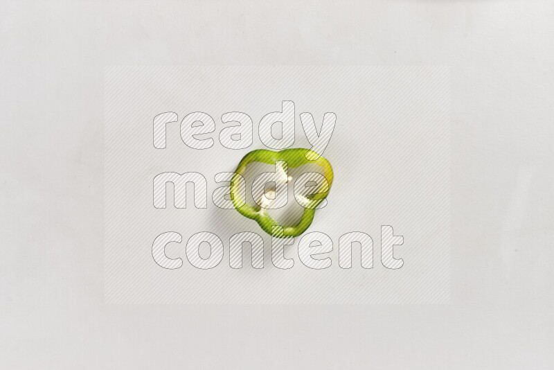 Green bell pepper slices on white background