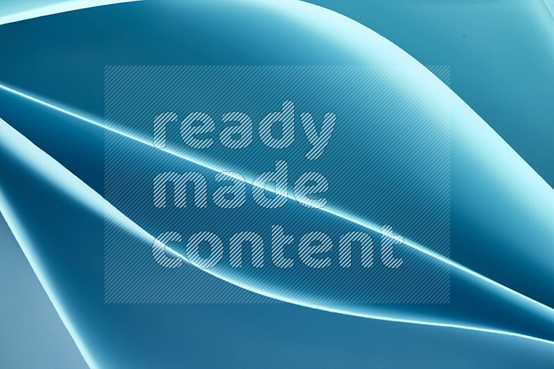 This image showcases an abstract paper art composition with paper curves in blue gradients created by colored light