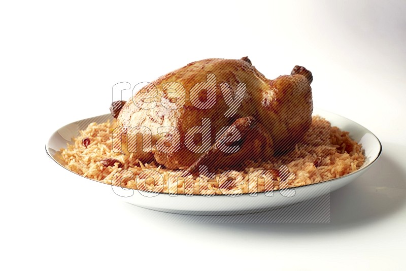 red basmati Rice with whole roasted chicken on a white plate with a silver rim direct on white background