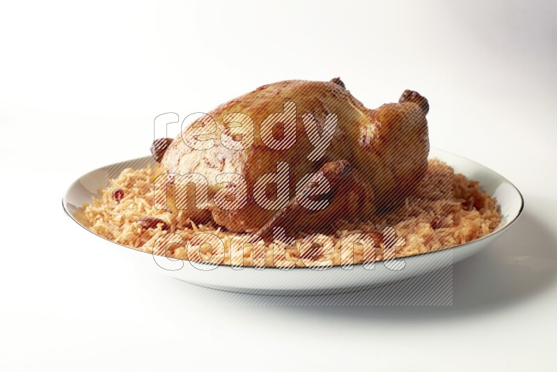 red basmati Rice with whole roasted chicken on a white plate with a silver rim direct on white background